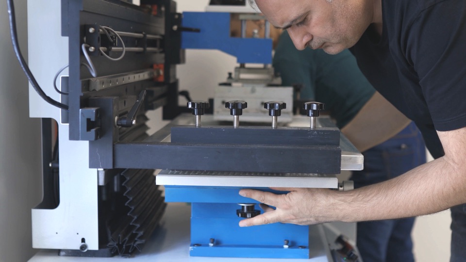 Technician adjusting a stencil printer